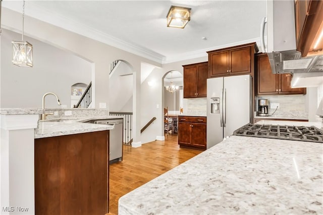 12110 Cora Ct, Concord, OH 44077 - kitchen with fridge with ice dispenser, dishwasher, light wood-style floors, hanging light fixtures, and ornamental molding