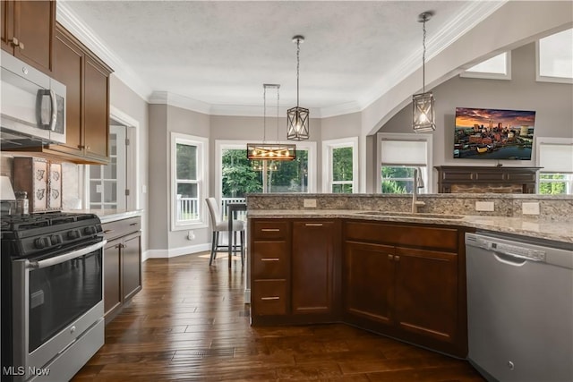 12110 Cora Ct, Concord, OH 44077 - kitchen featuring appliances with stainless steel finishes, healthy amount of natural light, dark wood-style floors, and crown molding