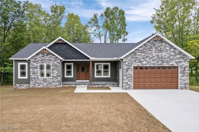 4720 Ashmont Ave SW, Canton, OH 44706 - view of front of house featuring stone siding, an attached garage, covered porch, and concrete driveway