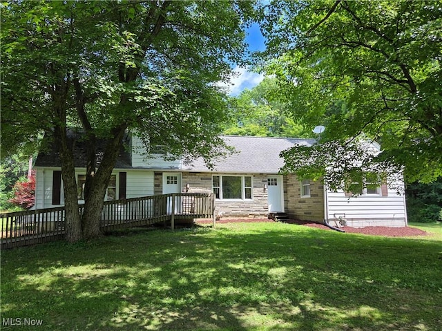 4581 Smith Stewart Rd, Vienna, OH 44473 - rear view of property with a wooden deck, a yard, stone siding, and a shingled roof