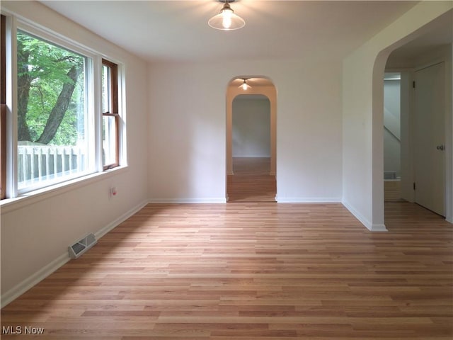4581 Smith Stewart Rd, Vienna, OH 44473 - unfurnished room featuring arched walkways, healthy amount of natural light, and light wood-style flooring