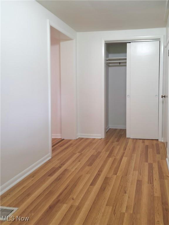 4581 Smith Stewart Rd, Vienna, OH 44473 - unfurnished bedroom featuring light wood finished floors and a closet