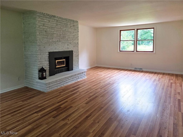 4581 Smith Stewart Rd, Vienna, OH 44473 - unfurnished living room featuring wood finished floors and a fireplace