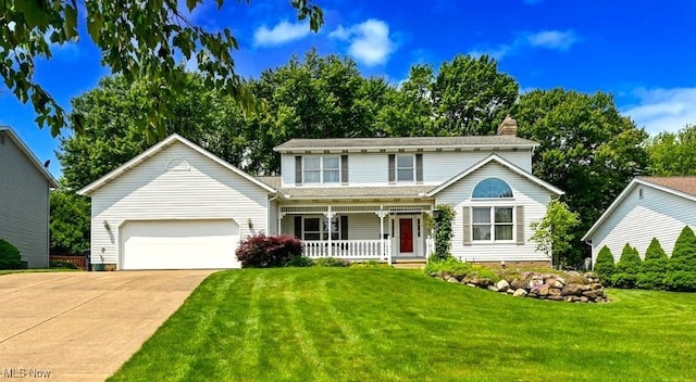 452 Herbert Rd, Akron, OH 44312 - traditional home featuring a porch, an attached garage, driveway, a front yard, and a chimney