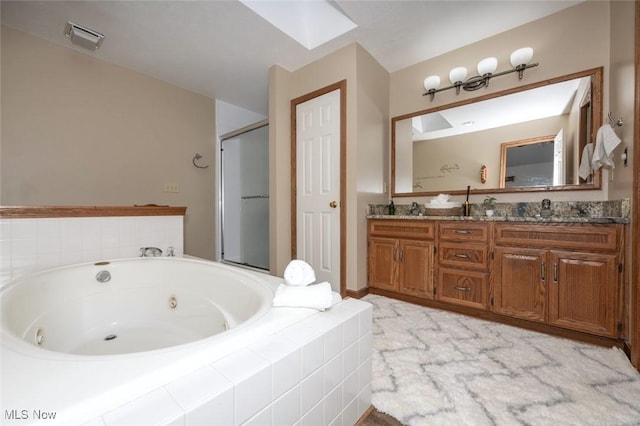 452 Herbert Rd, Akron, OH 44312 - bathroom featuring a jetted tub, double vanity, and a shower stall