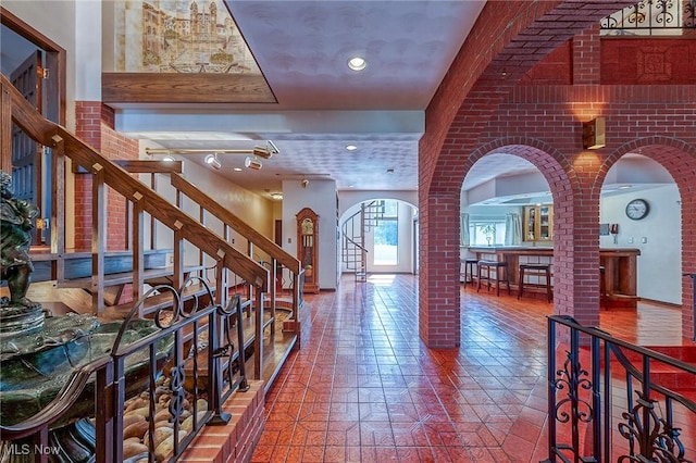 68 Caravel Pl, Wintersville, OH 43953 - foyer entrance with arched walkways, stairs, ornate columns, and brick wall