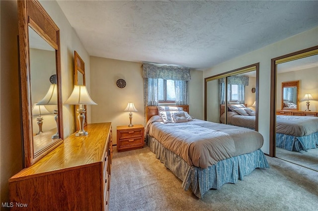 68 Caravel Pl, Wintersville, OH 43953 - bedroom featuring light colored carpet, a textured ceiling, and multiple closets