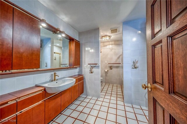 68 Caravel Pl, Wintersville, OH 43953 - full bath with vanity, tile patterned flooring, tile walls, and decorative backsplash