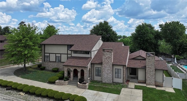 68 Caravel Pl, Wintersville, OH 43953 - view of front facade featuring a gate, a shingled roof, stone siding, and a chimney