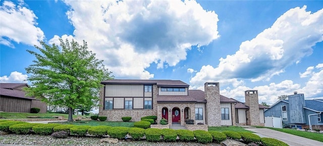 68 Caravel Pl, Wintersville, OH 43953 - view of front of house featuring stone siding and a chimney