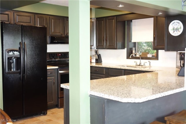 3545 Malley Ave, Coventry Township, OH 44319 - kitchen featuring black fridge with ice dispenser, stainless steel range with electric cooktop, dark brown cabinets, and light stone counters