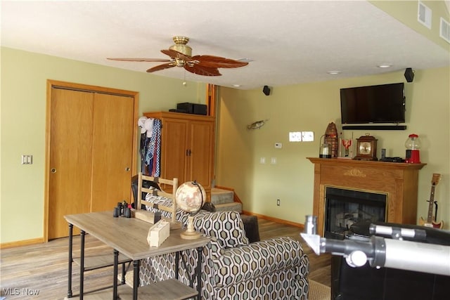 3545 Malley Ave, Coventry Township, OH 44319 - living area with light wood-style flooring, a ceiling fan, stairs, and a fireplace