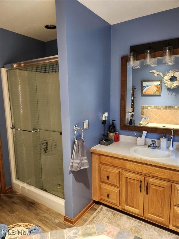 3545 Malley Ave, Coventry Township, OH 44319 - full bathroom featuring vanity, wood finished floors, and a stall shower