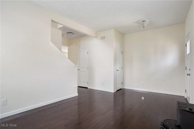 120 Glenridge Cir, Tallmadge, OH 44278 - unfurnished living room featuring dark wood-style flooring and baseboards