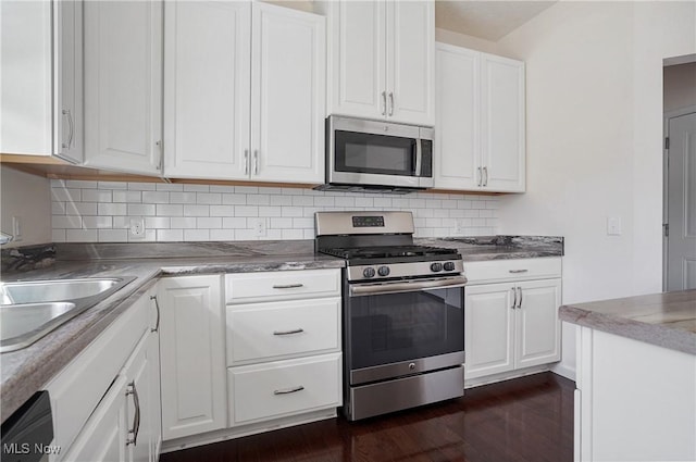 120 Glenridge Cir, Tallmadge, OH 44278 - kitchen featuring stainless steel appliances, white cabinetry, dark wood finished floors, and tasteful backsplash