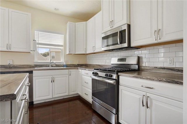120 Glenridge Cir, Tallmadge, OH 44278 - kitchen featuring appliances with stainless steel finishes, white cabinetry, and decorative backsplash