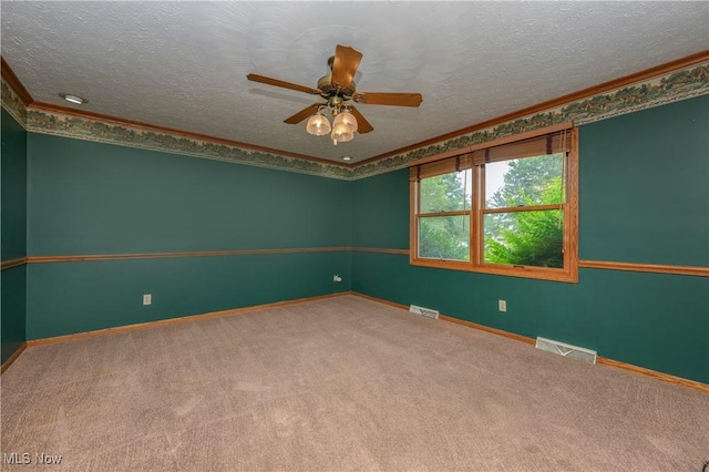6104 Shipslanding Ave NW, Canton, OH 44718 - unfurnished room with carpet, a ceiling fan, a textured ceiling, and crown molding