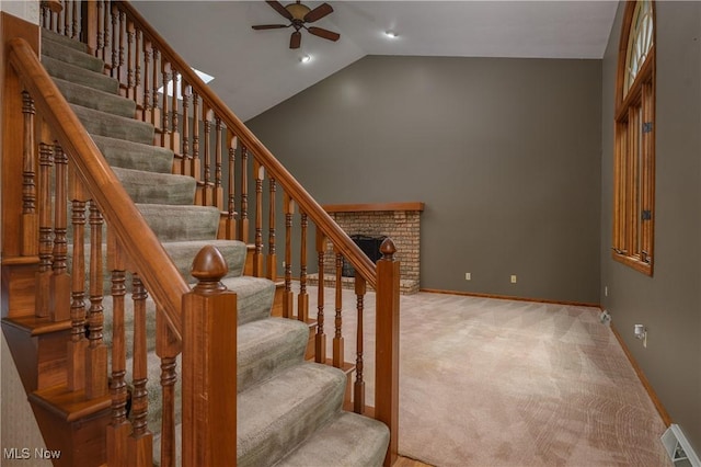 6104 Shipslanding Ave NW, Canton, OH 44718 - staircase featuring a ceiling fan, vaulted ceiling, carpet flooring, and a brick fireplace