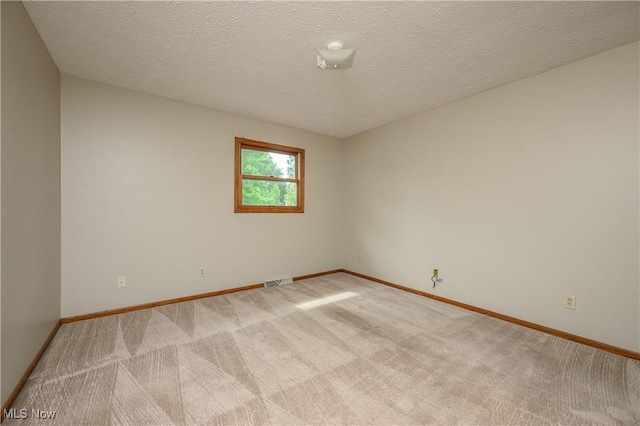 6104 Shipslanding Ave NW, Canton, OH 44718 - spare room featuring light colored carpet and a textured ceiling