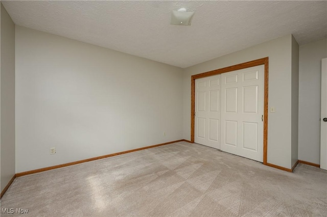 6104 Shipslanding Ave NW, Canton, OH 44718 - unfurnished bedroom featuring light carpet, a closet, and a textured ceiling