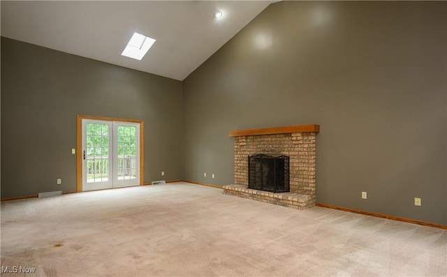 6104 Shipslanding Ave NW, Canton, OH 44718 - unfurnished living room featuring high vaulted ceiling, a skylight, a fireplace, and carpet