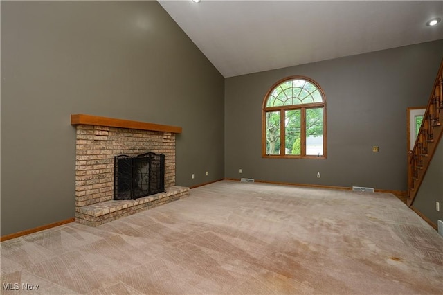 6104 Shipslanding Ave NW, Canton, OH 44718 - unfurnished living room featuring high vaulted ceiling, a fireplace, carpet flooring, stairs, and recessed lighting