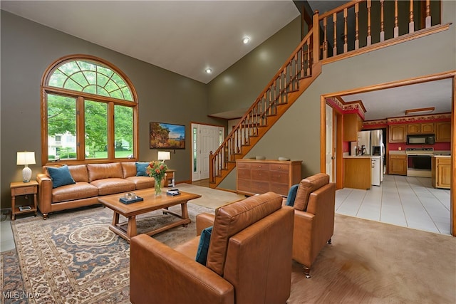 6104 Shipslanding Ave NW, Canton, OH 44718 - living area with high vaulted ceiling, stairs, light tile patterned flooring, and recessed lighting