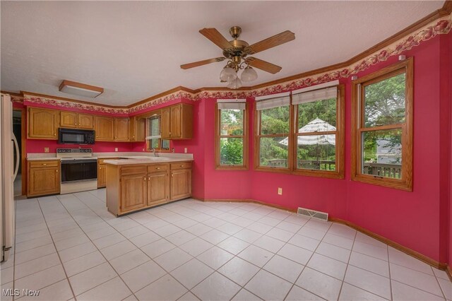 6104 Shipslanding Ave NW, Canton, OH 44718 - kitchen with white electric range, black microwave, light countertops, ornamental molding, and a peninsula