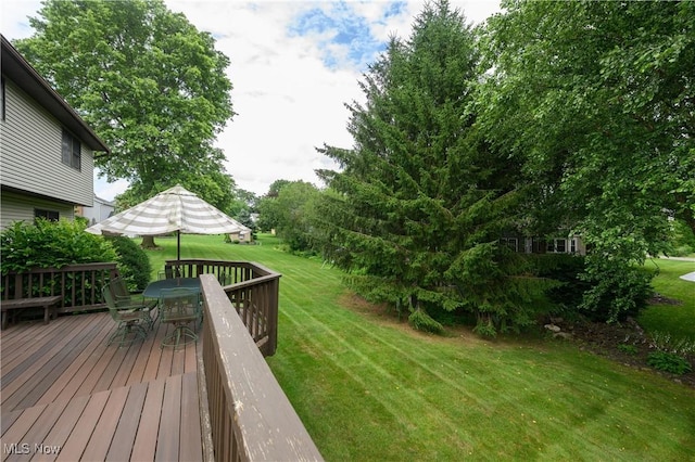 6104 Shipslanding Ave NW, Canton, OH 44718 - wooden deck featuring outdoor dining space and a yard