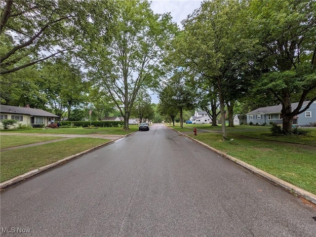 7567 Inland Dr, Olmsted Falls, OH 44138 - view of asphalt street featuring curbs and a residential view