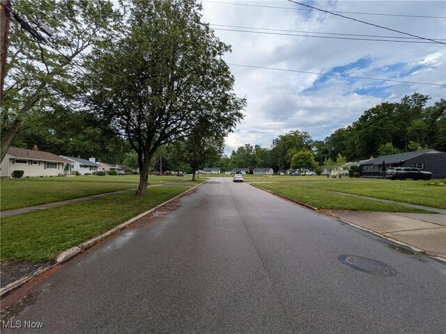 7567 Inland Dr, Olmsted Falls, OH 44138 - view of asphalt road with curbs and sidewalks