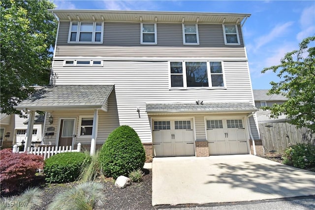 5500 Courtland Ct, Cleveland, OH 44102 - view of front of property with brick siding, a garage, and concrete driveway