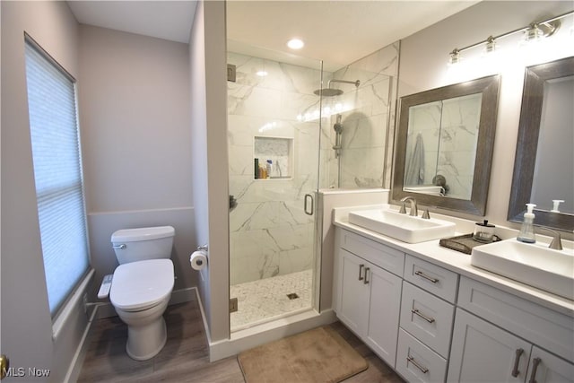 5500 Courtland Ct, Cleveland, OH 44102 - bathroom with a marble finish shower, double vanity, wood finished floors, and recessed lighting