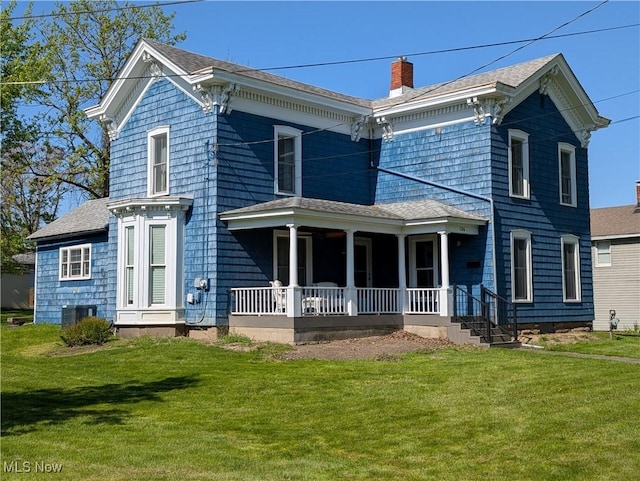 136 W Church St, Newton Falls, OH 44444 - rear view of house with covered porch, a yard, a chimney, and roof with shingles