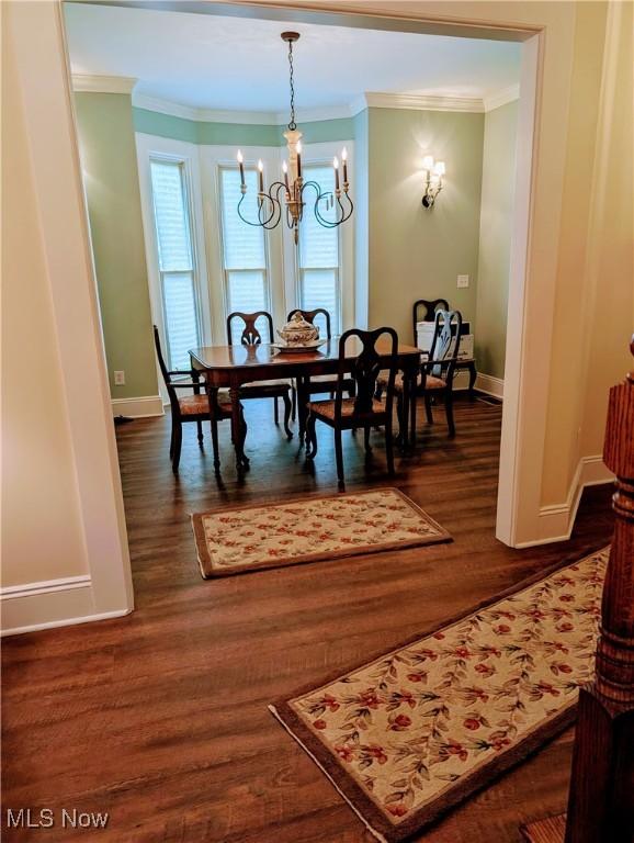 136 W Church St, Newton Falls, OH 44444 - dining area with a chandelier, ornamental molding, plenty of natural light, and dark wood finished floors