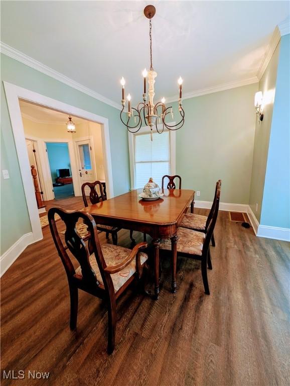 136 W Church St, Newton Falls, OH 44444 - dining room with a chandelier, dark wood finished floors, and crown molding