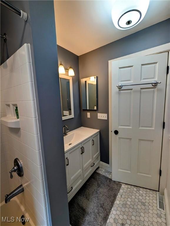 136 W Church St, Newton Falls, OH 44444 - full bath featuring vanity,  shower combination, and tile patterned flooring
