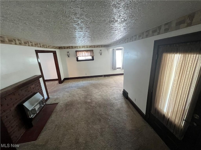 3731 Washington Park Blvd, Newburgh Heights, OH 44105 - unfurnished living room with a textured ceiling, carpet floors, and heating unit