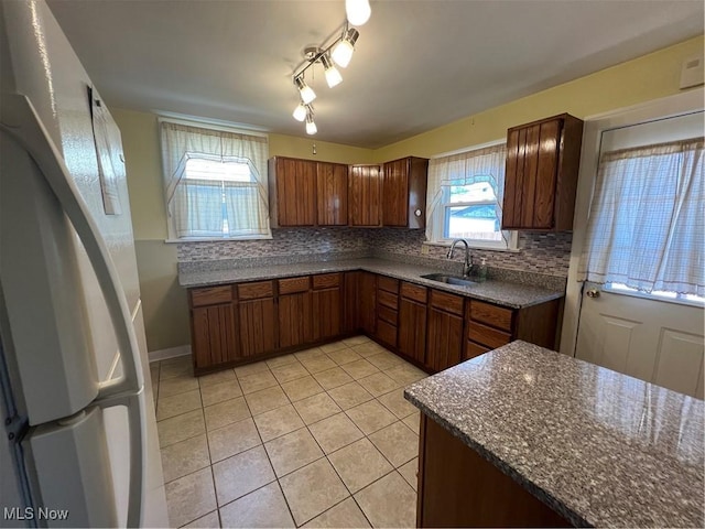 3731 Washington Park Blvd, Newburgh Heights, OH 44105 - kitchen with light tile patterned flooring, tasteful backsplash, freestanding refrigerator, and dark stone counters
