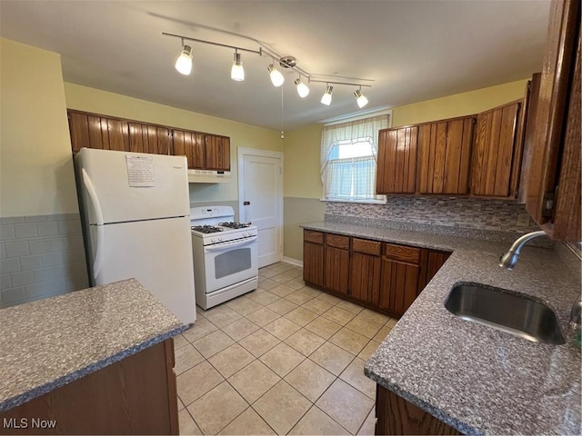 3731 Washington Park Blvd, Newburgh Heights, OH 44105 - kitchen with white appliances, custom range hood, light tile patterned floors, backsplash, and dark countertops