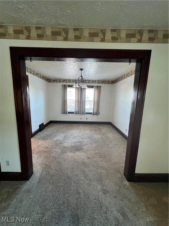 3731 Washington Park Blvd, Newburgh Heights, OH 44105 - unfurnished room with a textured ceiling, carpet, and a chandelier