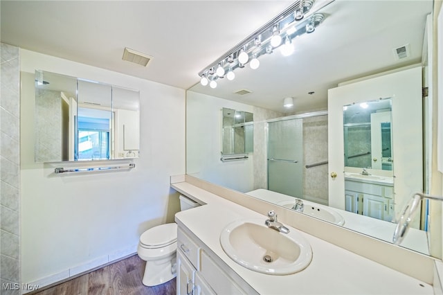 140 Fox Hollow Dr Unit 206C, Mayfield Heights, OH 44124 - bathroom featuring a shower with door, vanity, and wood finished floors