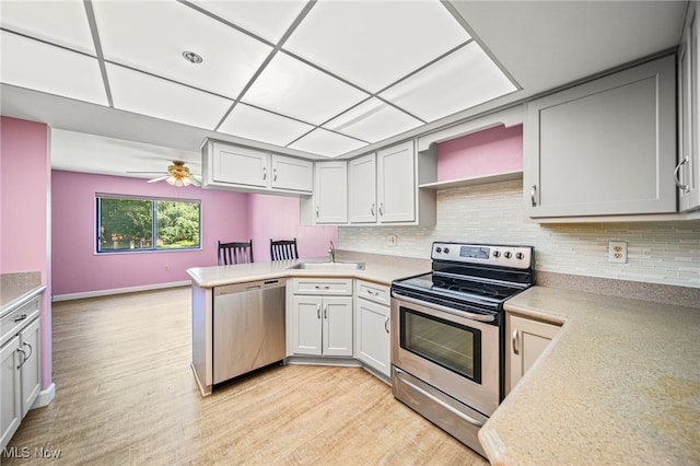 140 Fox Hollow Dr Unit 206C, Mayfield Heights, OH 44124 - kitchen featuring appliances with stainless steel finishes, backsplash, light wood-type flooring, and a peninsula