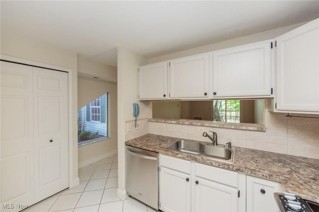 6131 Center St Unit 106, Mentor, OH 44060 - kitchen featuring stainless steel dishwasher, light tile patterned floors, white cabinets, and decorative backsplash