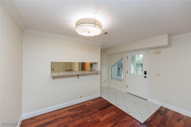 6131 Center St Unit 106, Mentor, OH 44060 - entrance foyer with light wood-style floors and crown molding