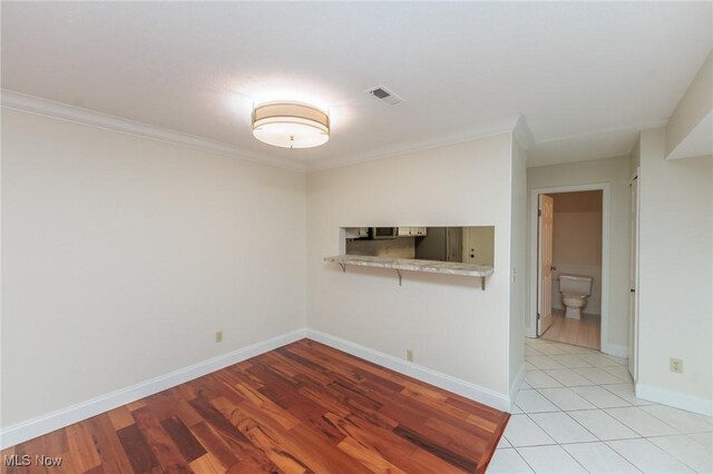 6131 Center St Unit 106, Mentor, OH 44060 - unfurnished room featuring light wood-style flooring and crown molding