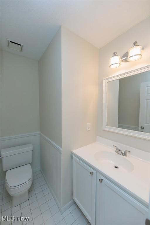 6131 Center St Unit 106, Mentor, OH 44060 - bathroom with vanity, a wainscoted wall, and tile patterned floors