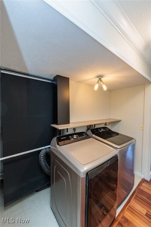 6131 Center St Unit 106, Mentor, OH 44060 - laundry area featuring washer and clothes dryer and light wood-style flooring