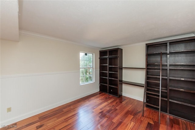 6131 Center St Unit 106, Mentor, OH 44060 - unfurnished bedroom featuring wood finished floors, wainscoting, and crown molding