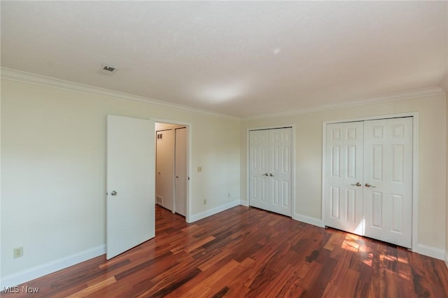 6131 Center St Unit 106, Mentor, OH 44060 - unfurnished bedroom with wood finished floors, two closets, and ornamental molding